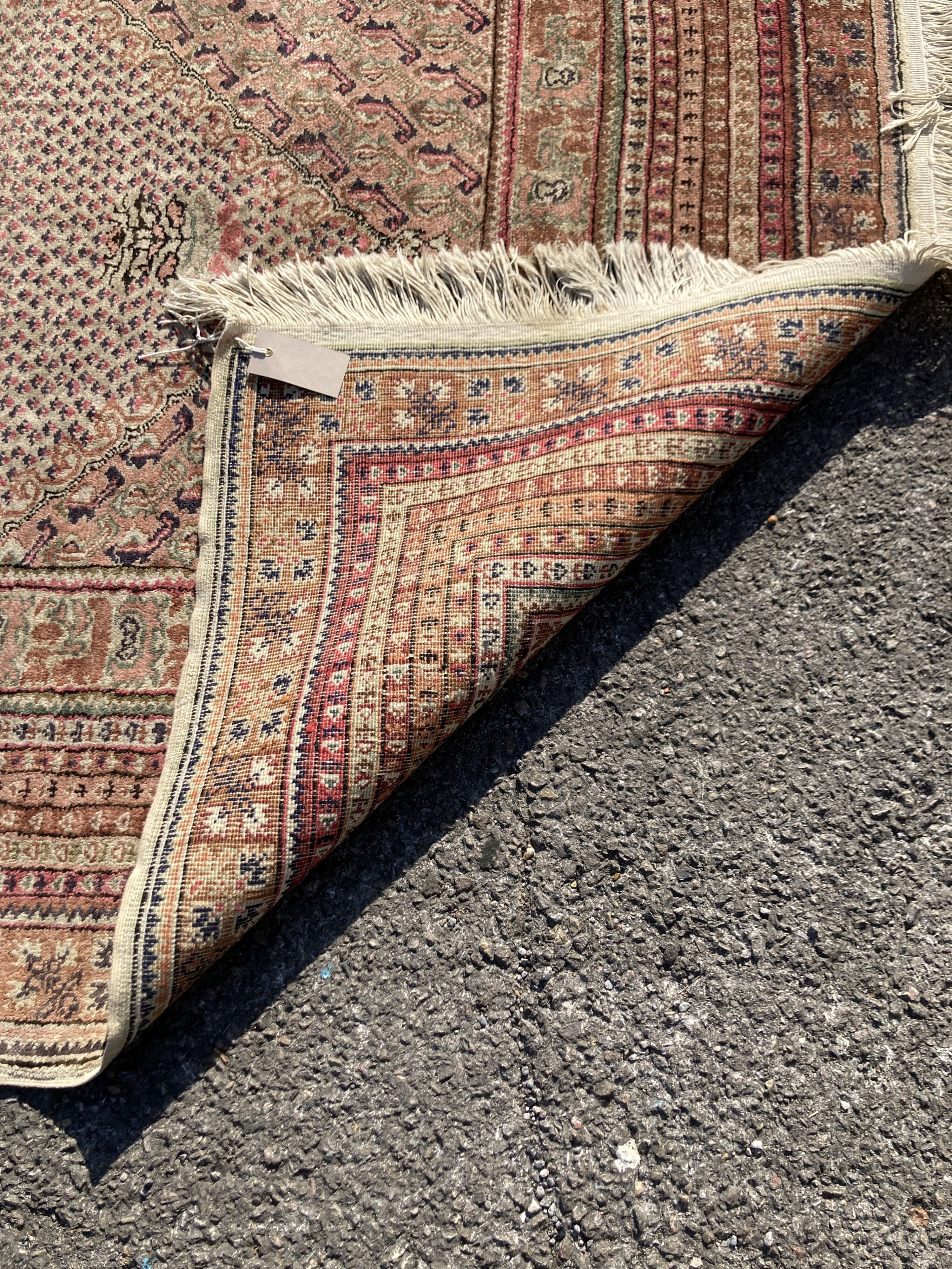 A North West Persian red ground rug, decorated with Saz leaf field, 190 x 125cm